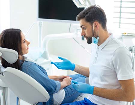 Dentist explaining dental implant post-op instructions in Azle to patient
