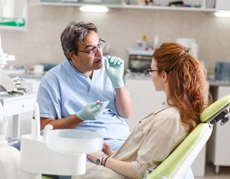 a dentist talking to a patient about getting a smile makeover