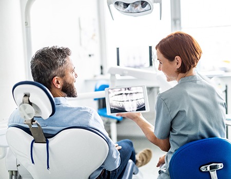dentist explaining dental X-ray to patient 