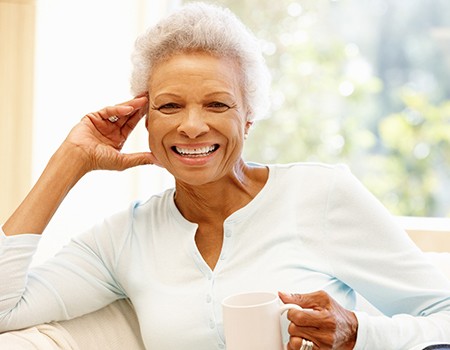 An older woman smiling after learning how dental implants work in Azle