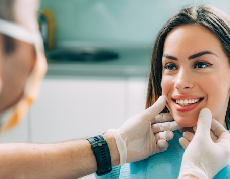 Dentist examining woman's smile