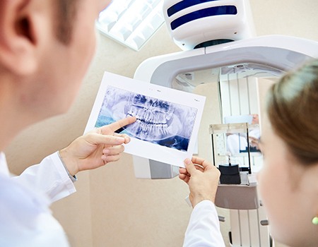 Dentist and patient reviewing an X-ray