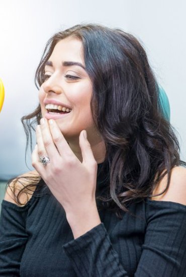 woman looking at her new dental bridge in Azle in a mirror 