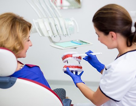 Azle dentist instructing patient during dental checkup