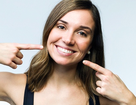 Woman pointing to her teeth