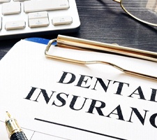 dental insurance form on a blue clipboard 