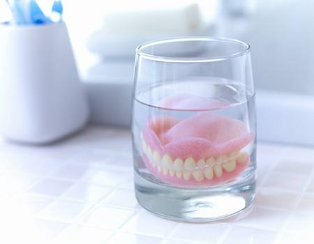 Dentures in Azle soaking in solution