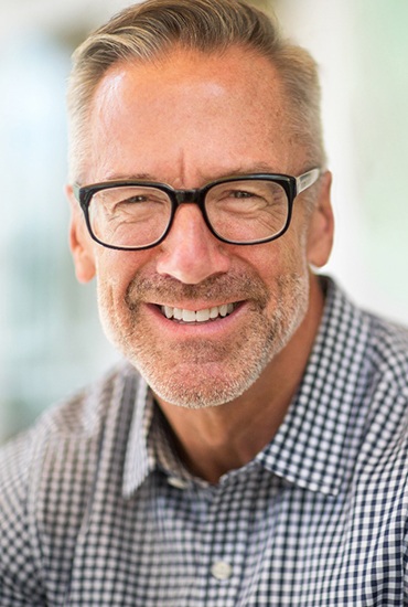 Closeup of mature gentleman smiling with dentures