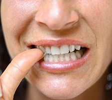 Close-up of woman biting her fingernails