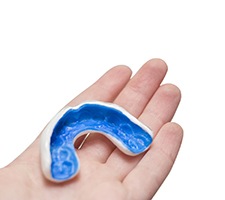 Close-up of hand holding a mouthguard