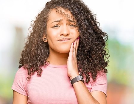 Woman with failed dental implant in Baltimore, MD with jaw pain