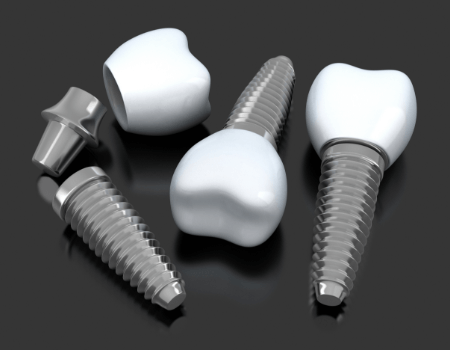 three dental implants in Azle lying on a flat surface