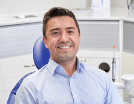 smiling man sitting in the dental chair