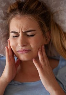 Man worriedly checking his gums in mirror