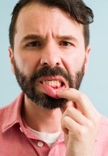 man pointing to inflamed gums