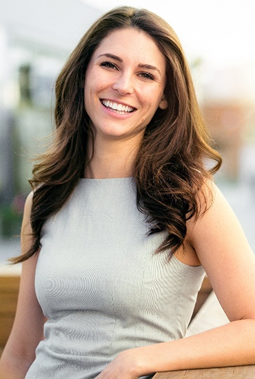 woman smiling after getting metal-free restorations in Azle