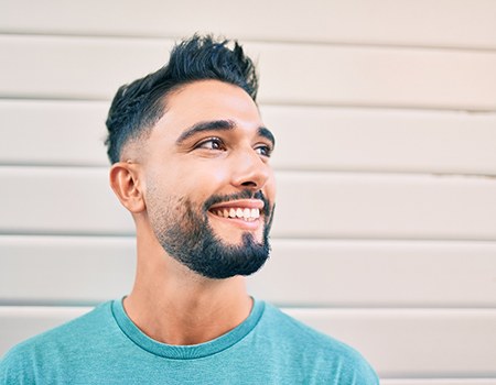 man smiling after getting metal-free restorations in Azle