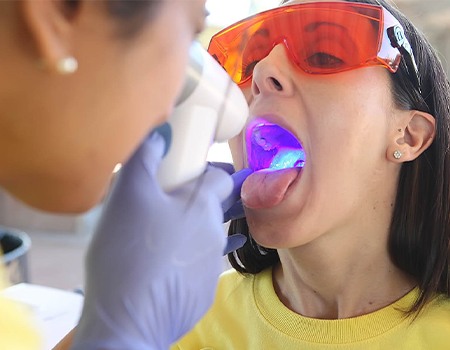 Woman receiving oral cancer screening