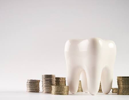 a tooth surrounded by coins