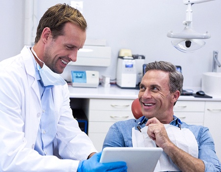 Man smiling at dentist after root canal therapy in Azle