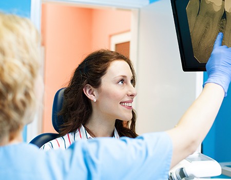 Dental patient looking at digital x-rays