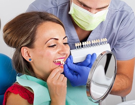 woman in red shirt trying on veneers 