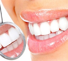 Close-up of white teeth with dental mirror