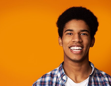 smiling young adult in a plaid shirt