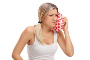 woman holding cold compress to mouth