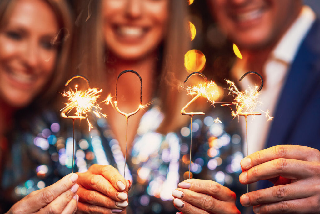 smiling people holding 2022 sparklers