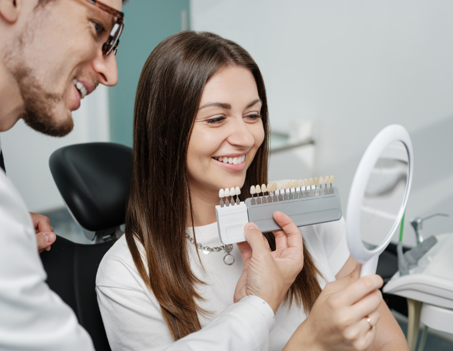 Dentist showing patient veneers