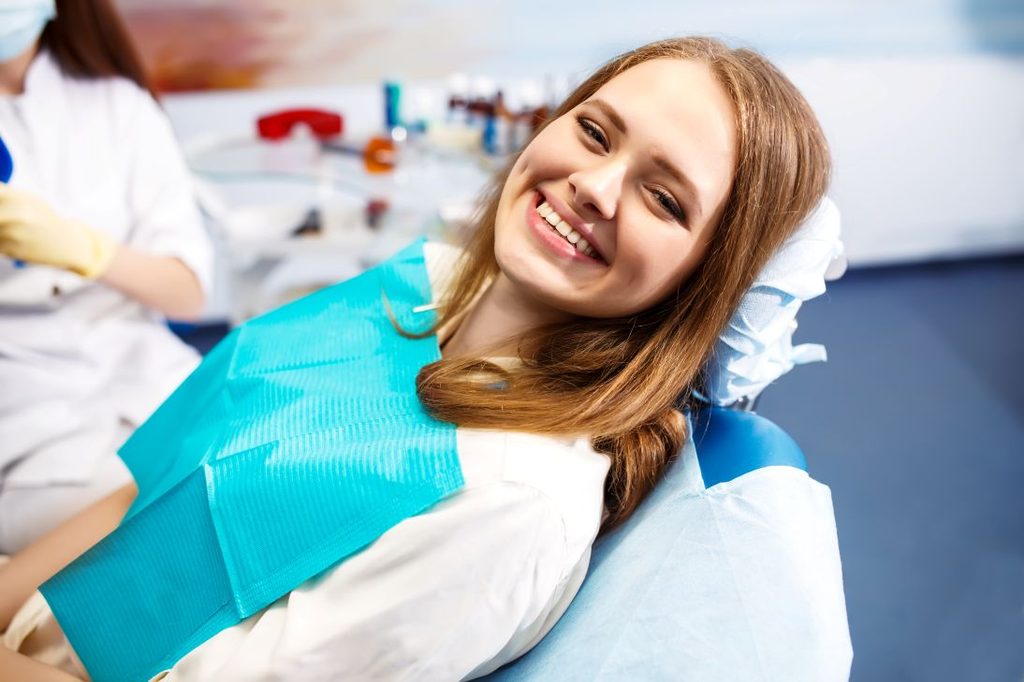 A woman smiling after a root canal